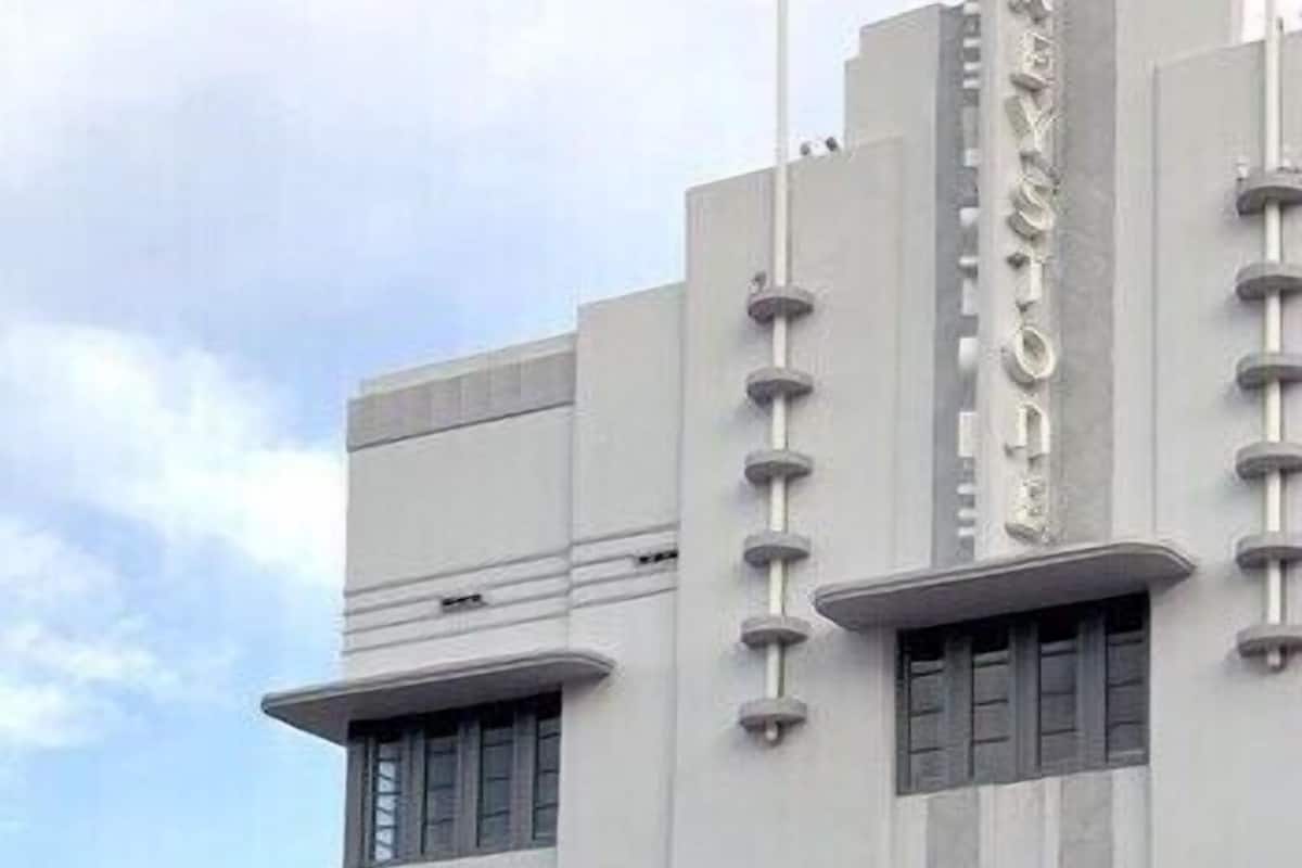 A building with a modern architectural style, featuring vertical lines and a prominent central column.