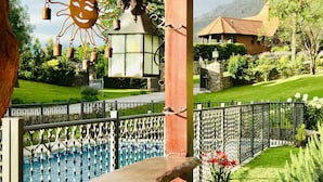 A scenic view of a garden with a fountain, a gazebo, and a mountain in the background. - Casa Chumamaya (Merlo)
