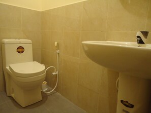 A bathroom with a toilet and a sink. - New Sanmi Resort (Malabe)