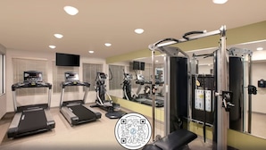 A gym with treadmills, elliptical machines, and weightlifting equipment. - WoodSpring Suites Dallas Plano Central Legacy Drive (Plano)