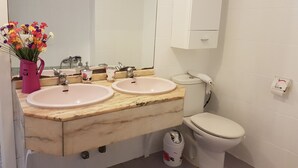 A bathroom with two sinks, a toilet, a mirror, and a trash bin. - Los Cristianos Apartment Nirvana Tenerife South (Los Cristianos)