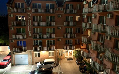 A multi-story building with balconies and air conditioning units, labeled "Pensione Rova."