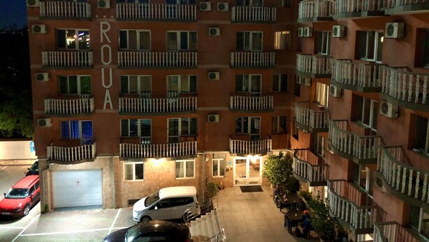 A multi-story building with balconies and air conditioning units, labeled "Pensione Rova." - Pensiune Roua (Arad)