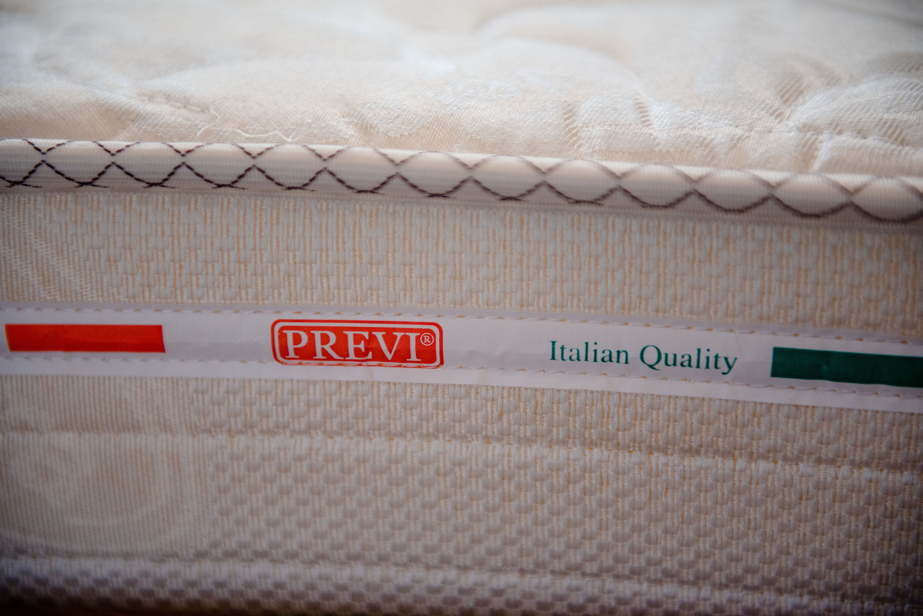 A mattress with a label indicating "PREV" and "Italian Quality".