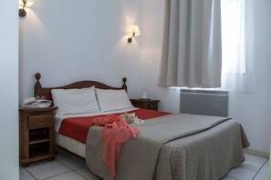 A bedroom with a bed, bedside tables, a window with curtains, and a radiator. - Apartment in Bergheim near Picturesque Town (Bergheim)