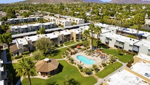 A residential area with modern apartment buildings, a swimming pool, and a mountain in the background. - Walk to Old Town | 2 King Beds + 4 Heated Pools (Scottsdale)