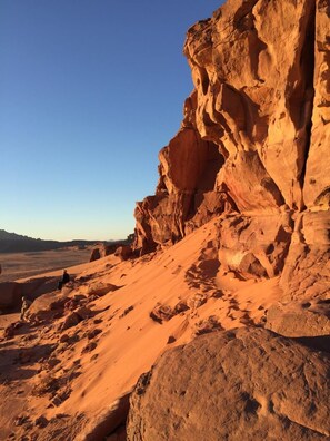 A desert landscape with a prominent rock formation.