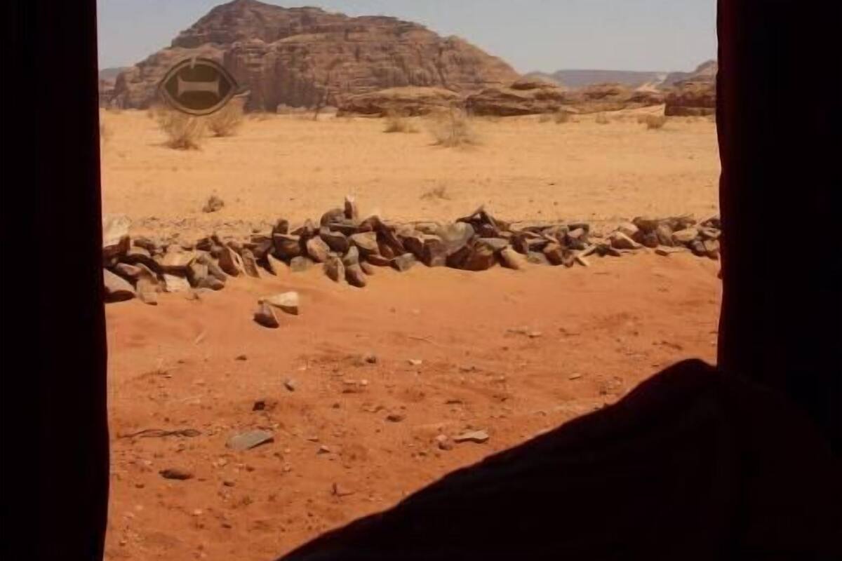 A desert landscape with rocky formations and a clear sky.