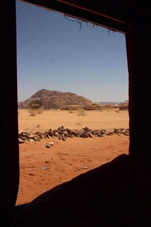 A desert landscape with rocky formations and a clear sky.