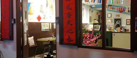 A cozy cafe interior with a mosaic table, a coffee machine, and a menu on the table.