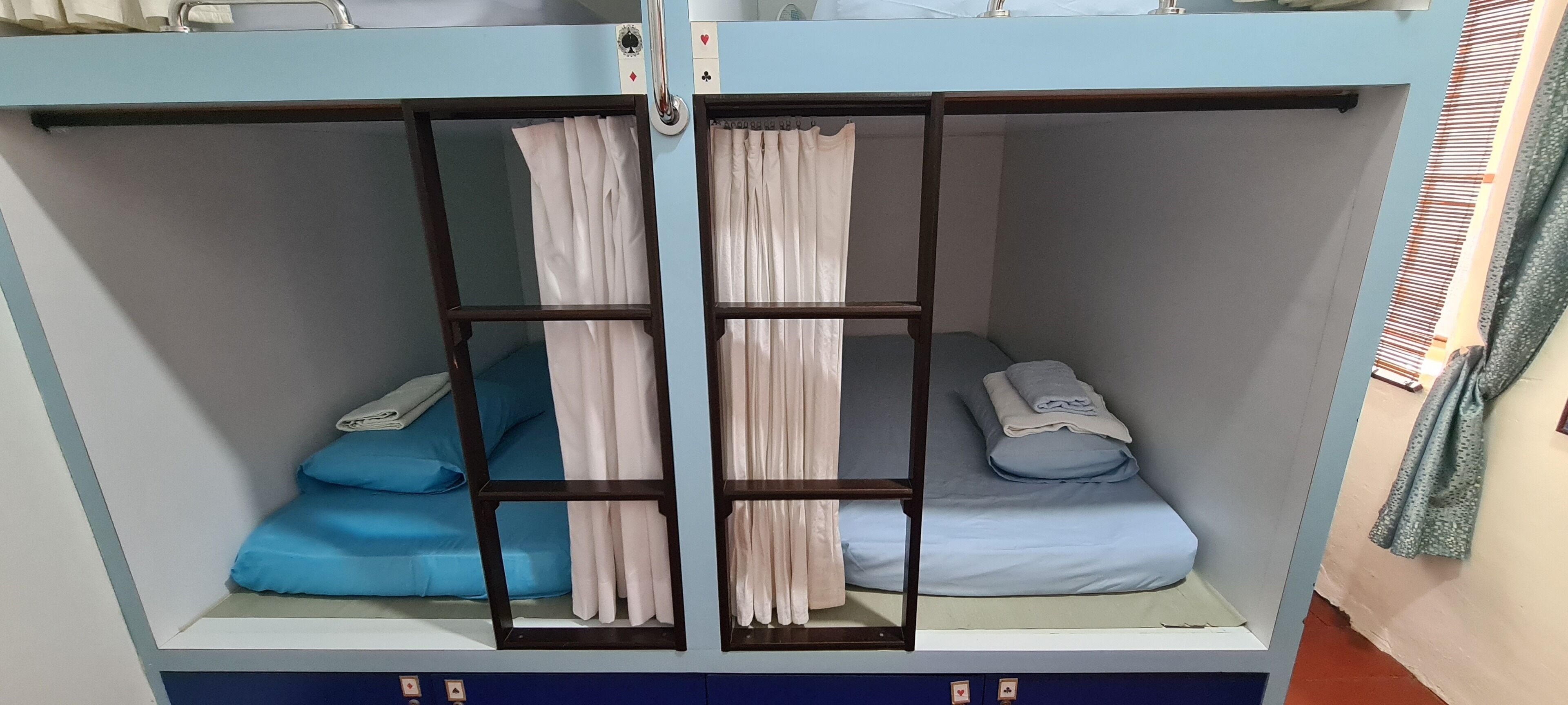 A bunk bed with two levels, each with a mattress and pillows.