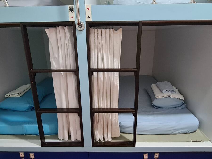 A bunk bed with two levels, each with a mattress and pillows.