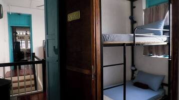 A bunk bed room with a sign that reads "SNAKE" on the door.