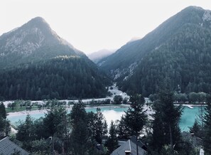 A mountainous landscape with a river and a small settlement.