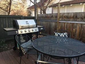 An outdoor patio with a grill, a round table, and two chairs. - Elderberry- Salt Hot Tub, Wood Fireplace, 100+mbps Wifi, Walkable to Downtown (Bend)