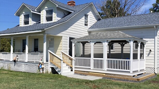A two-story house with a covered porch and a fenced yard. - BEAUTIFUL PEACEFUL, SCENIC, ENJOY CRABS N FISH MEMORABLE, FREE TOUR OF AREA! (Fishing Creek)