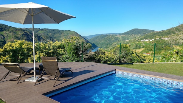 A swimming pool with a view of a valley and mountains.