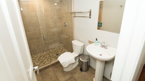 A bathroom with a shower, toilet, and sink. - Wrigley Field MVP Suite 1 Bedroom Apartment (Chicago)