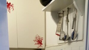 A compact kitchen with a refrigerator, a kettle, and a sink. - THE FISHERMAN'S HOUSE (Ospedaletti)