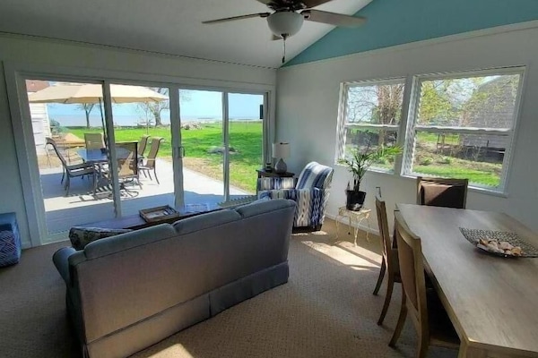 Additional living space in the sun room with lake views.