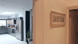 A modern kitchen with stainless steel appliances, a built-in oven, and a large window. - Lovely Central Bath House- w/ Parking (CG) (Bath)