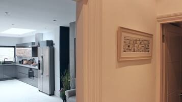 A modern kitchen with stainless steel appliances, a built-in oven, and a large window.