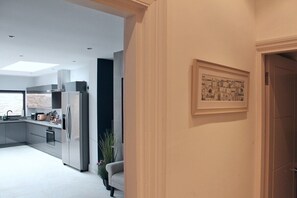 A modern kitchen with stainless steel appliances, a built-in oven, and a large window. - Lovely Central Bath House- w/ Parking (CG) (Bath)