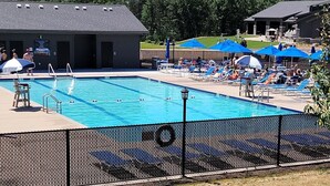 A rectangular swimming pool with a black fence in the foreground. - The Sixth Green at Lake Arrowhead by Sand Valley Golf Resort (Nekoosa)