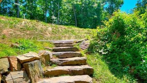 A stone staircase leading uphill in a natural setting.