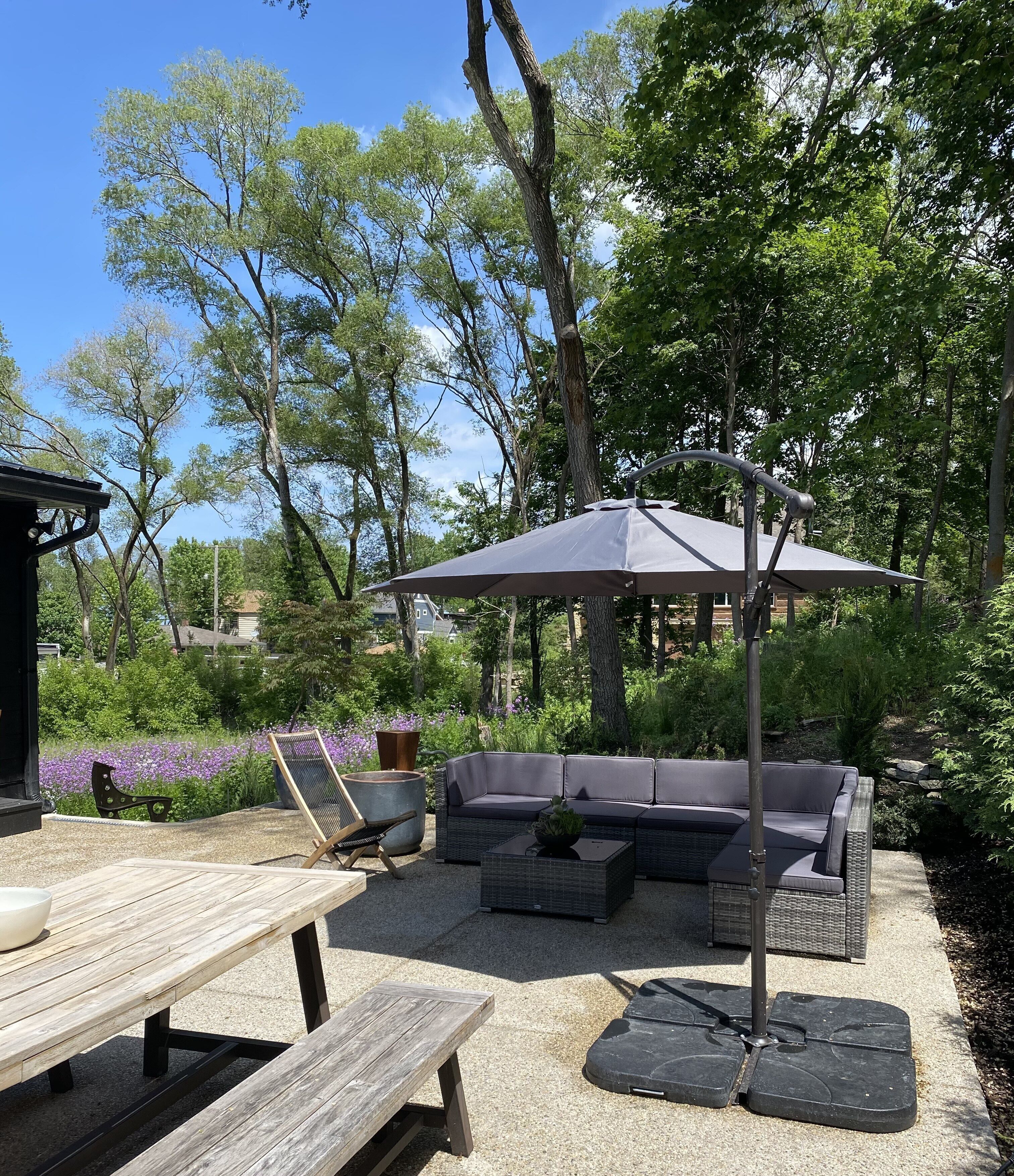 Patio off of kitchen with dinning table and lounge area 