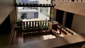 A modern apartment with a balcony overlooking a cityscape. - SweetSuites at Pine Crest New Manila / #T3-1012 (Quezon City)