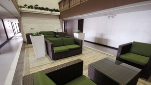 A modern lobby with a seating area featuring sofas and a coffee table. - SweetSuites at Pine Crest New Manila / #T3-1012 (Quezon City)