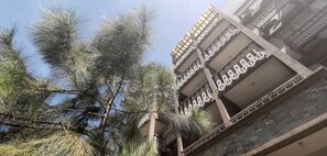 A multi-story building with balconies and a clear sky.