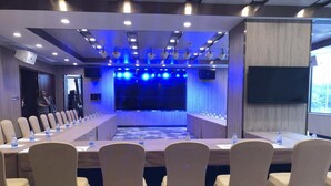 A conference room with a long table, beige chairs, and a blue carpet. - Shenzhen Sichuan Hotel (Shenzhen)