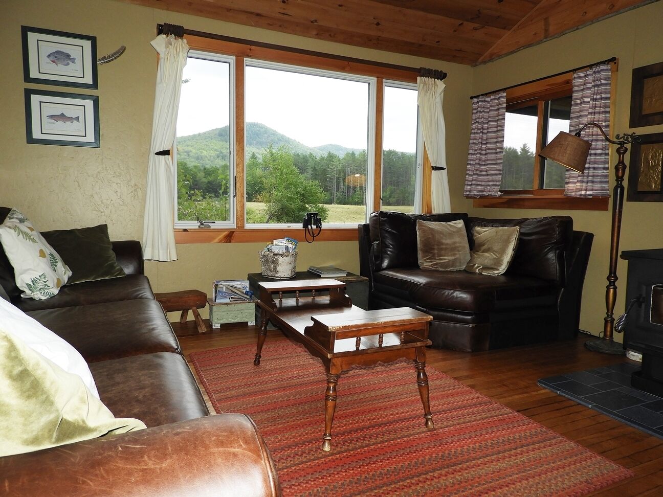 A cozy living room with a leather sofa, wooden coffee table, and a fireplace.