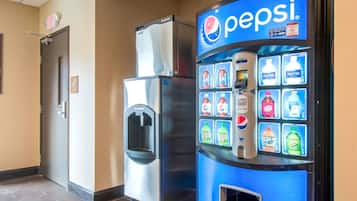 A vending machine with a Pepsi logo, a water dispenser, and a refrigerator.