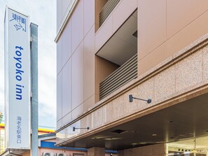 A modern building with a sign for 'Toyoko Inn' and a sign for 'Sea Name Station'. - Toyoko Inn Ebina Station Higashi (Ebina)