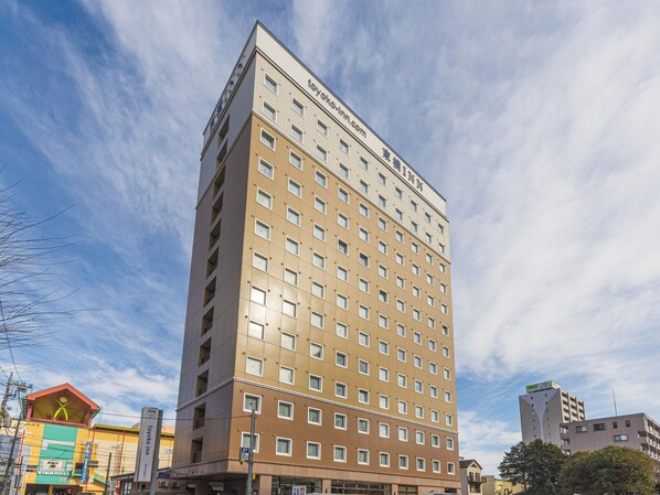 A tall hotel building with multiple floors and a prominent sign at the top. - Toyoko Inn Ebina Station Higashi (Ebina)