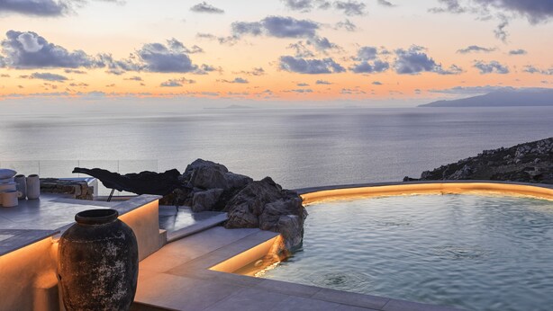 A serene pool area with a view of the sea and sunset. - Myconian Panoptis Escape - Small Luxury Hotels of the World (Mykonos)