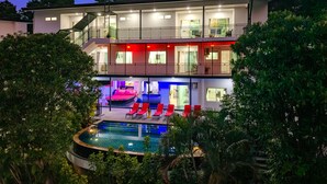 A two-story building with a balcony, a pool, and outdoor seating. - Private Pool Villa for your family and friends / Private Chef available (Tambon Chalong)