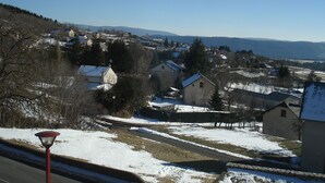A snow-covered landscape with houses and a clear sky.