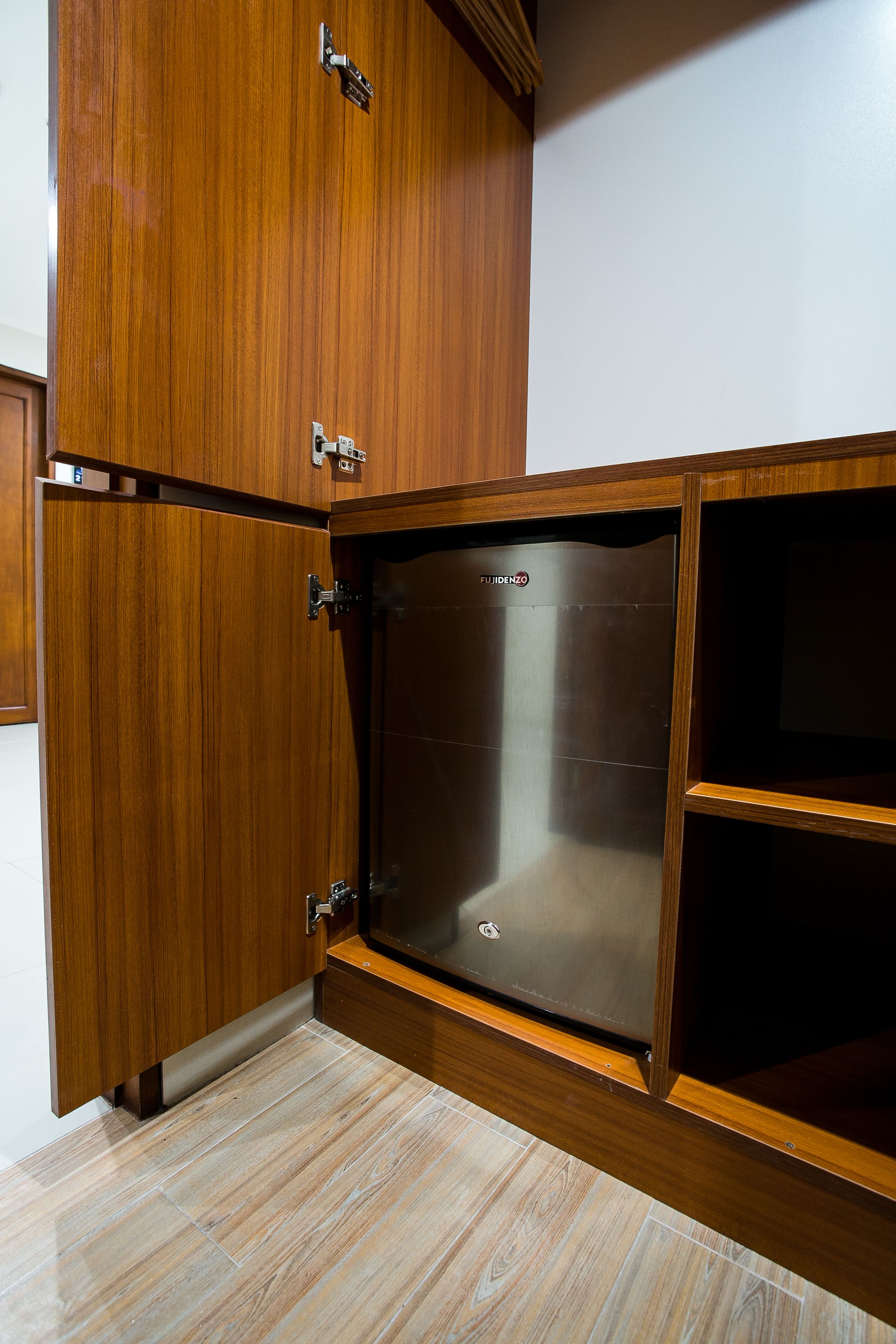 A wooden cabinet with a built-in microwave.