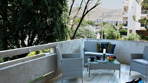 A balcony with wicker furniture, a glass table, and a bag. - Glyfada Center - Aries Newly Modern Home (Glyfada)