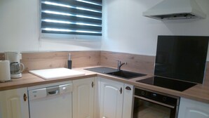 A compact kitchen with a dishwasher, oven, and a coffee maker. - Cottage in a 1850 Bastide with infinity pool et counter current swimming system  (Eyguières)