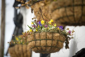 A hanging basket filled with various flowers and dried plants. - The Horse & Farrier Inn and The Salutation Inn (Keswick)