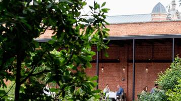 A brick building with a covered patio area.