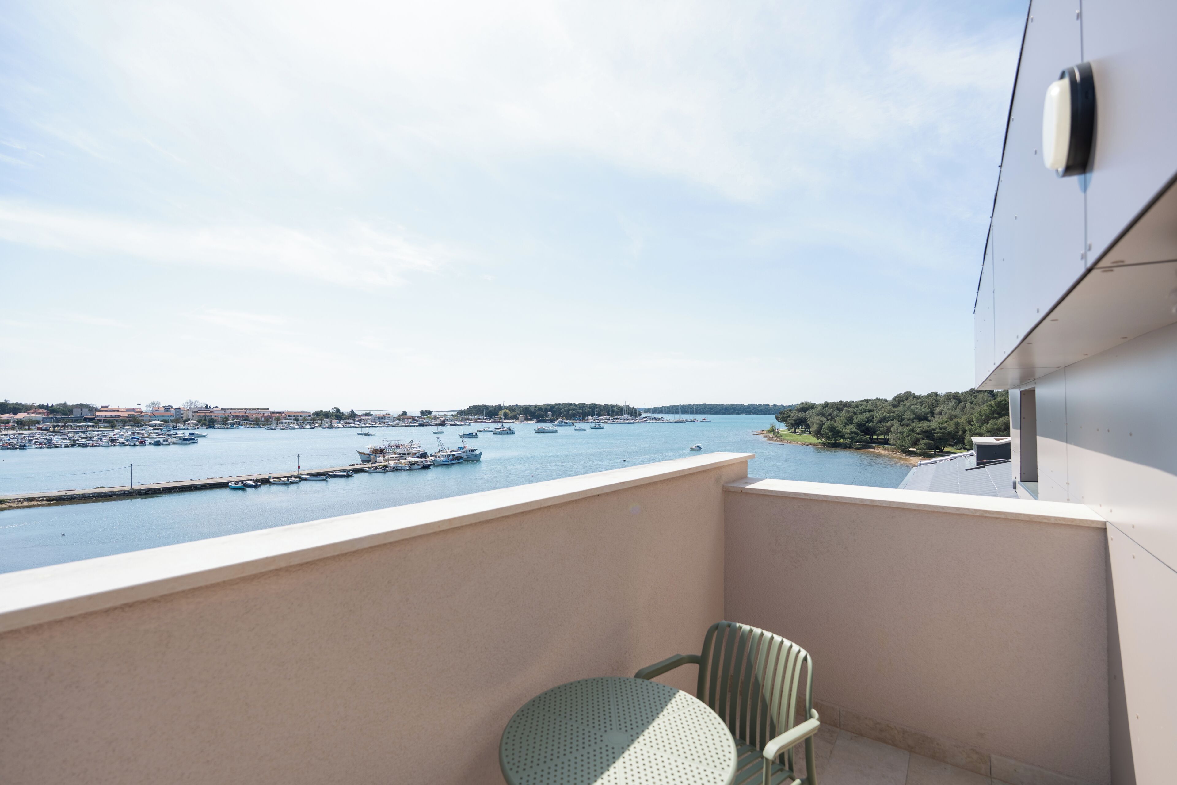 A balcony with a view of a marina and water.