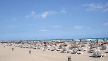 On the beach, sun loungers, beach umbrellas, beach towels