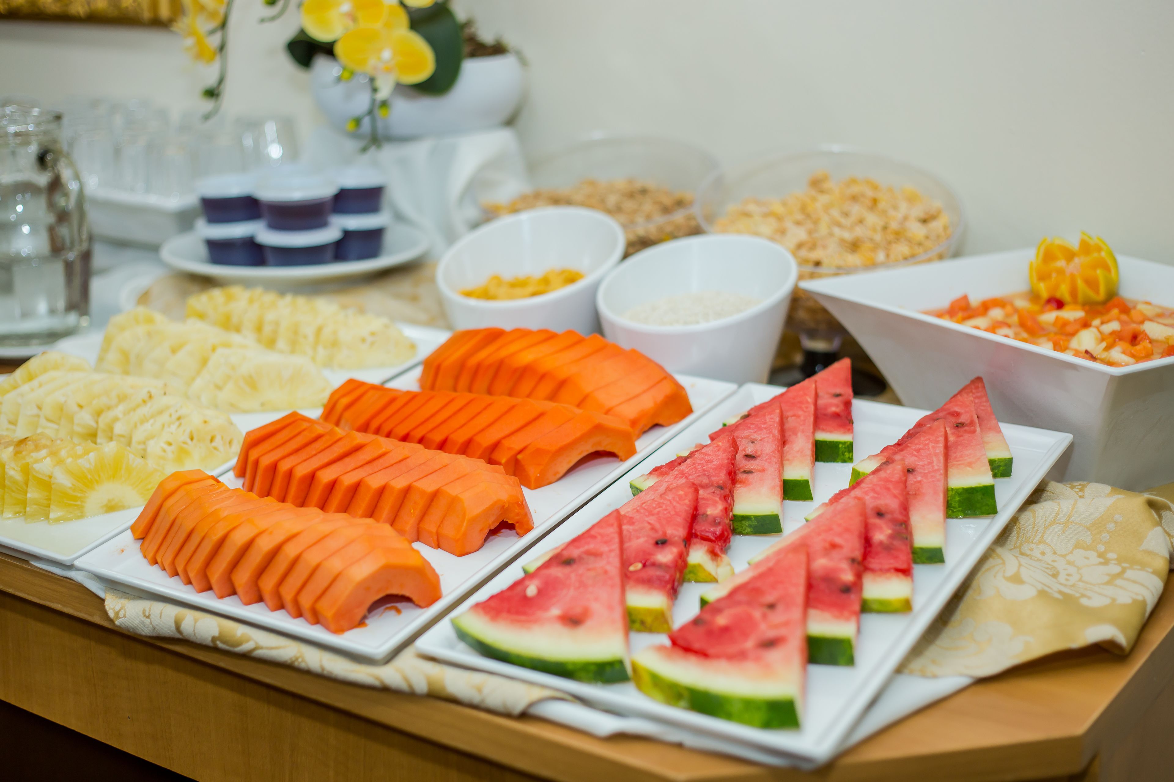 A buffet with various fruits and dishes.
