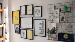 A wall with various framed artworks and a map. - Cabrera & Gascon (Buenos Aires)